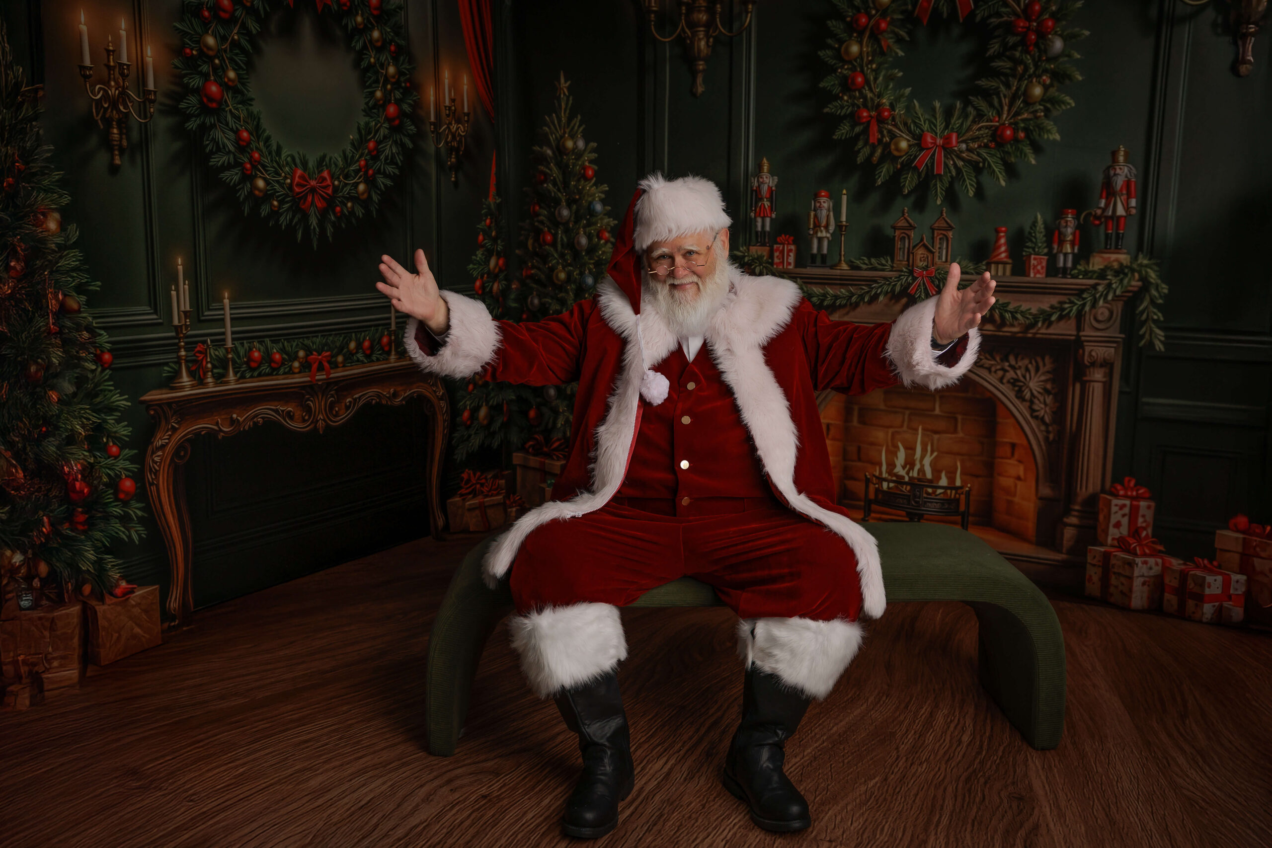 A happy santa sits with arms wide open for a hug