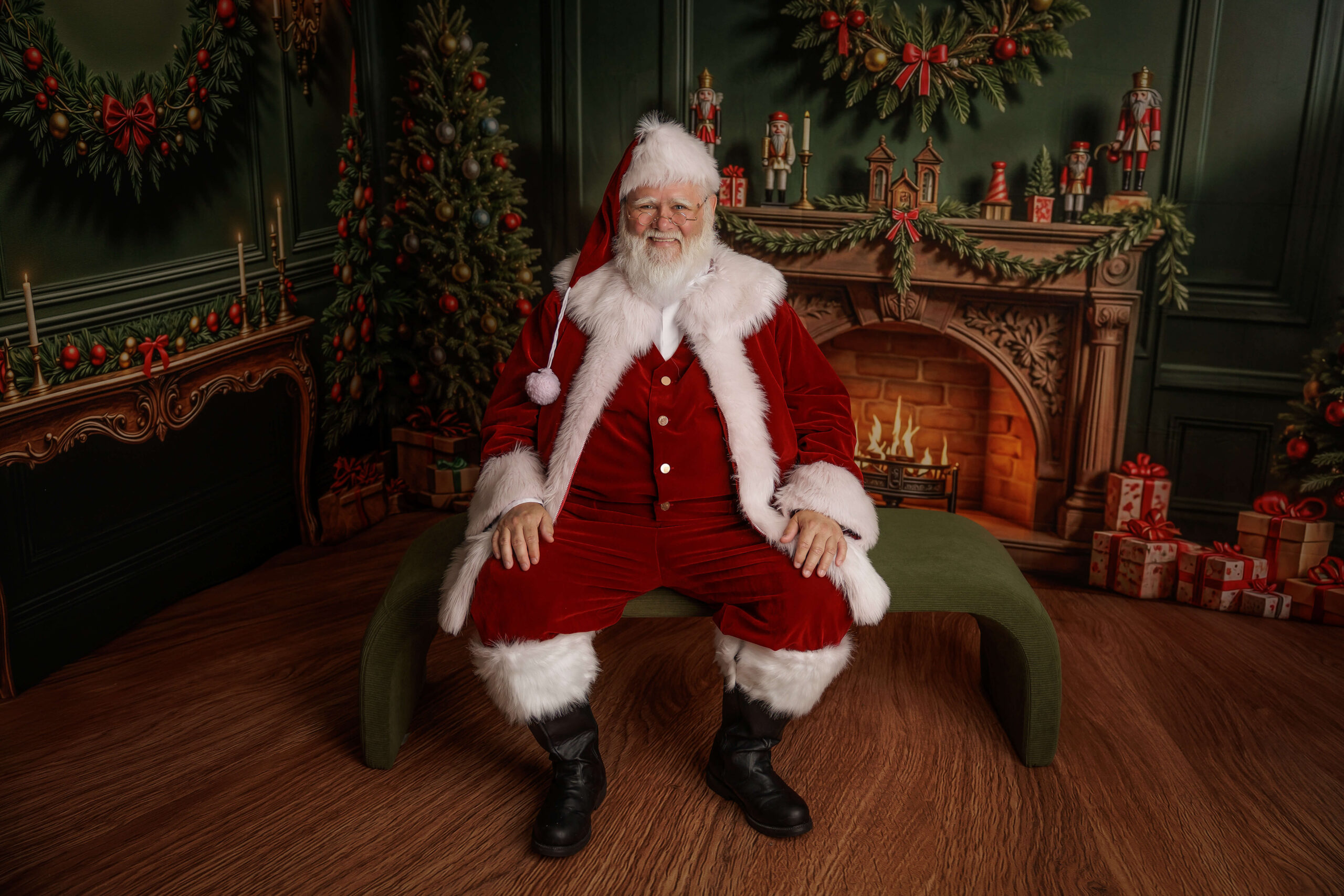 A happy Santa in Springfield, IL sits on a bench in a christmas room